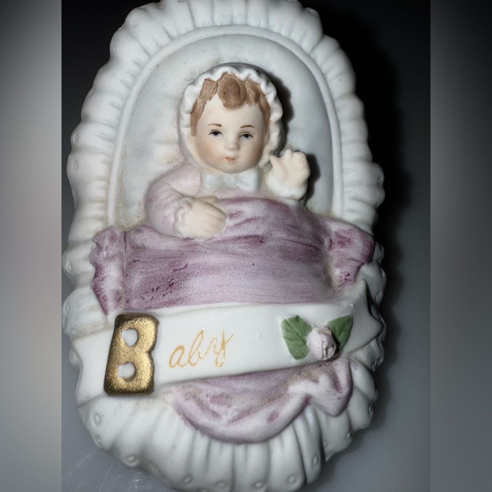 Charming Baby Figurine with Gold and Pink Accents